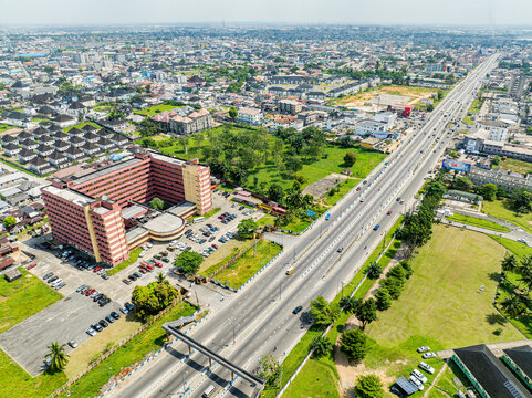 Aerial view of federal secretariat building and busy highway in urban landscape, Port Harcourt, Nigeria.