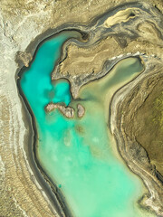 Obraz premium Aerial View of Turquoise Lake and Eroded Landscapes