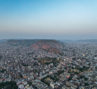 Aerial view of vibrant cityscape with expansive skyline and surrounding mountains, Subhash Nagar, Jaipur, Rajasthan, India.