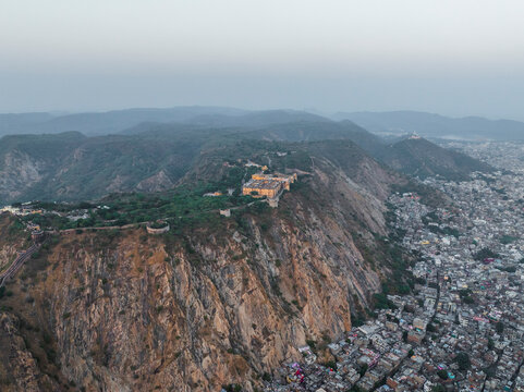 Aerial view of nahargarh fort on a hill overlooking the beautiful cityscape and mountainous landscape, jaipur, india.