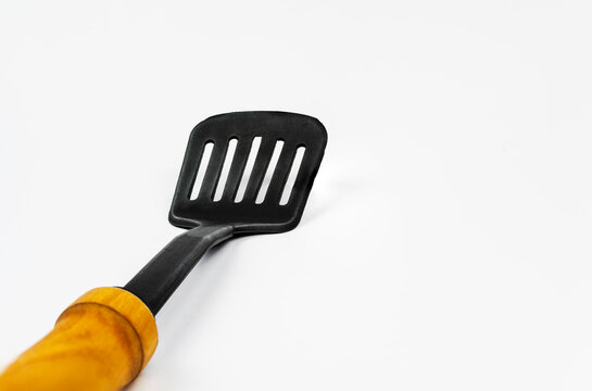 Black silicone cooking spatula for cooking, isolated on white background. NATIONAL COOKING DAY. National Spatula Day