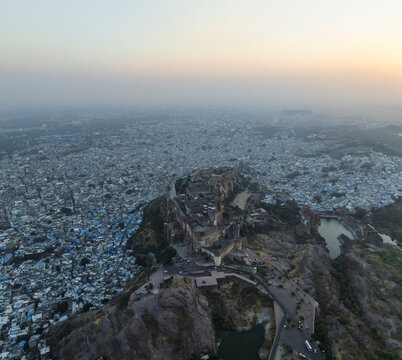 Aerial view of mehrangarh fort with cityscape at sunset, jodhpur, rajasthan, india.