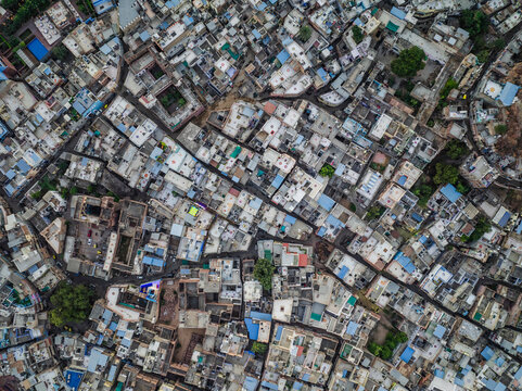 Aerial view of densely populated rooftops and colorful buildings in a maze-like layout, Jodhpur, India.