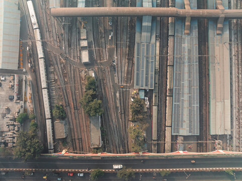 Aerial view of bustling train station with railway tracks and modern urban infrastructure, Ajmeri Gate, New Delhi, India.