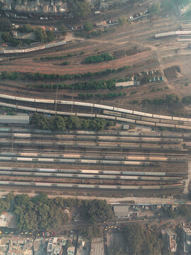 Aerial view of busy train station with organized tracks and dense urban area, Ajmeri Gate, New Delhi, India.