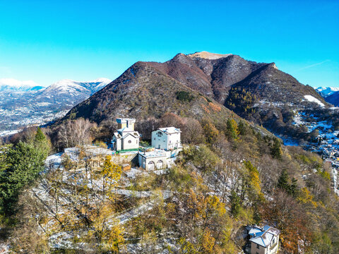 Aerial view of picturesque Monte Bre with beautiful autumn colors and serene valley, Bre sopra Lugano, Switzerland.
