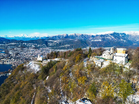 Aerial view of beautiful Monte Bre with serene landscape, clear sky, and scenic lake, Bre sopra Lugano, Switzerland.