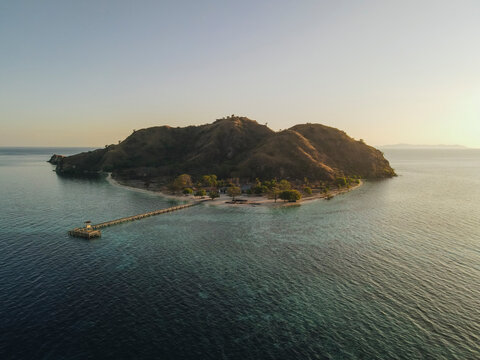 Aerial landscape view of Kanawa Island beach with long bridge dock.