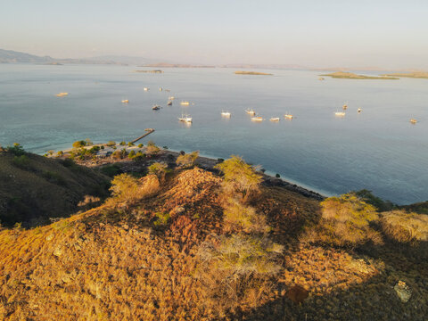 Aerial landscape view of Kanawa Island beach with long bridge dock.