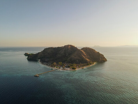 Aerial landscape view of Kanawa Island beach with long bridge dock.