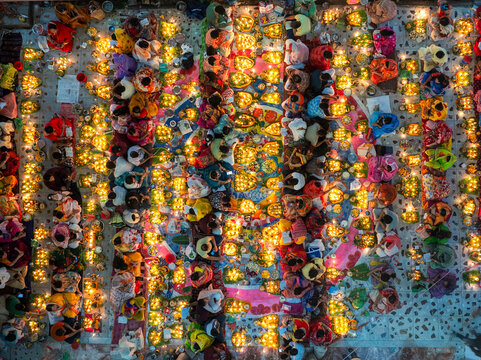 Aerial view of colorful candles and lights during the Kartik Vrata festival with a gathering of people, Gendaria, Dhaka, Bangladesh.