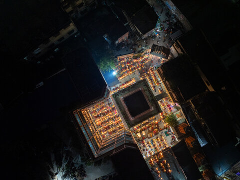 Aerial view of the vibrant kartik vrata festival with illuminated temple and gathering crowd, Gendaria, Bangladesh.