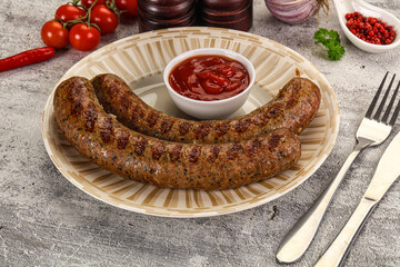 Grilled beef sausages with sauce