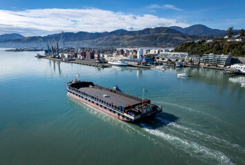 Nelson, New Zealand - 22 July 2024: Aerial view of cruise ships in a tranquil harbor surrounded by mountains and cityscape, Nelson, New Zealand.