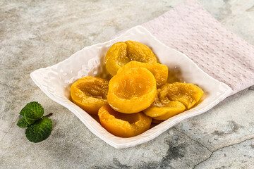 Canned marinated peach in syrop