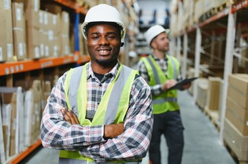 Two warehouse workers checking and controlling boxes in warehouse, Professional warehouse workers