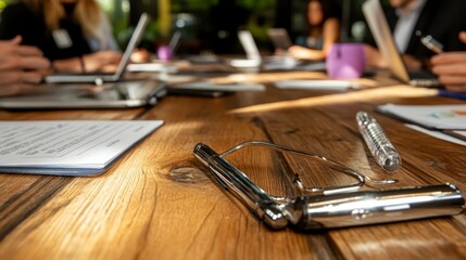 Business Meeting Table Documents Pens and Laptops in Focus