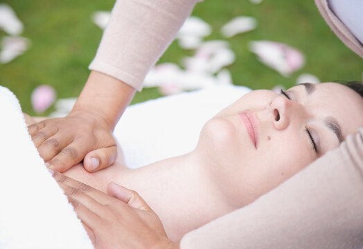 Close up of a woman receiving a chest massage outdoor
