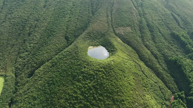 Arcing aerial view of Lagoinha lake on Terceira island, Serreta, Azores