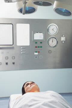 Woman Lying on Operating table under Examination light
