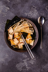 Asian-style soup with squid, tofu and enoki mushrooms.