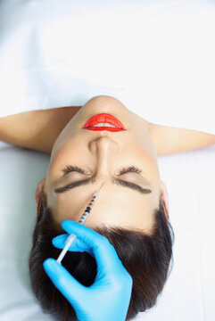 Woman Receiving Botox Injection on Forehead
