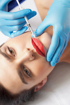 Woman Receiving Botox Injection on Lips - Close-up view
