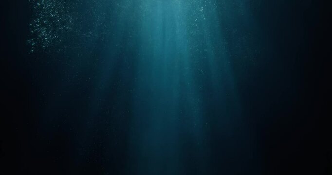 Stunning 4K slow-motion footage of underwater god rays piercing the ocean surface, with enchanting beams of light flickering. Ideal VFX background for diving, snorkeling, and summer adventures.