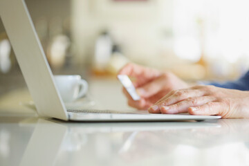Close up of Man's Hands Holding Credit Card and Using Laptop
