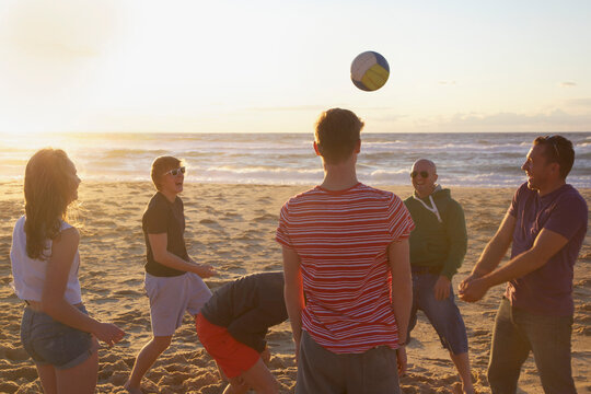 Group of People Playing Volleyball on Beach
