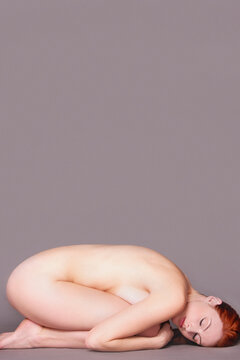 Nude Woman Curled Up on Floor
