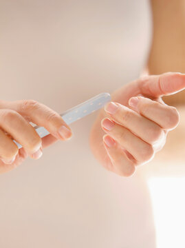 Woman Filing Fingernails, Close up view
