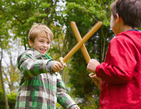 Two Boys Playing at Sword Fighting
