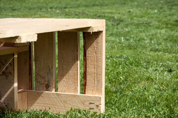 
A large piece of wooden palisade placed on a green lawn.
