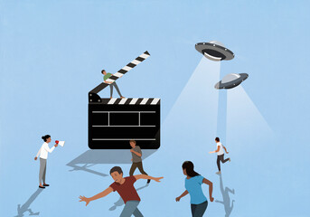 Director guiding actors running from UFO on movie set
