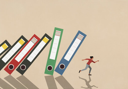Businesswoman running from falling binders
