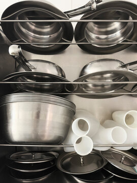Still life urine bottles and stainless steel bedpans on racks
