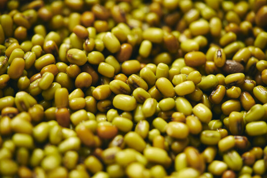 Full frame close up heap of green and brown mung beans
