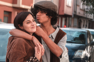 Fototapeta premium Young couple in love hugging on the street