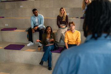 Students asking questions during lesson in modern university classroom