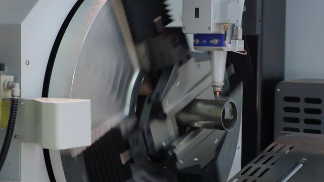 Close up scene the fiber laser cutting machine cutting  machine cut the stainless steel tube. The hi-technology sheet metal manufacturing process by laser cutting machine. technical concept background