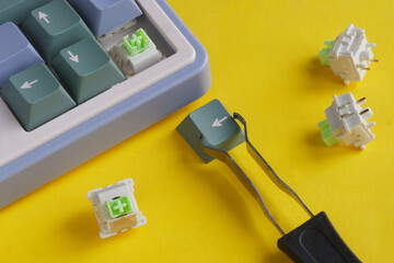Keyboard switch replacement process showing tools and components, keycap and puller on a vibrant...