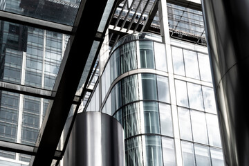 The modern city exudes artistic flair through its unique glass and metal structures, reflecting light and creating an intriguing urban composition.