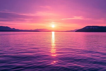 Fototapeta premium Serene sunset over a tranquil lake with purple hues reflecting on water.