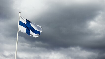 Waving Finland flag on a cloudy day