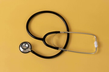 Stethoscope on a yellow surface