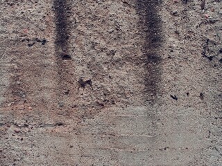 Brown concrete wall with soft hints of black dirt