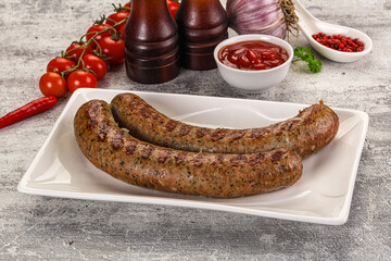 Grilled beef sausages with sauce
