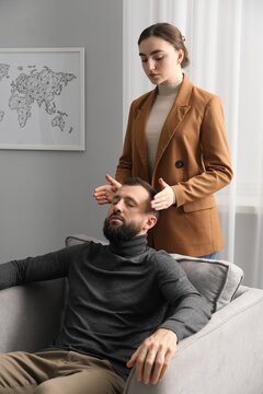 Psychologist working with patient during hypnosis session indoors