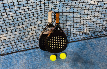Padel tennis racket. Background with copy space. Sport court and balls.